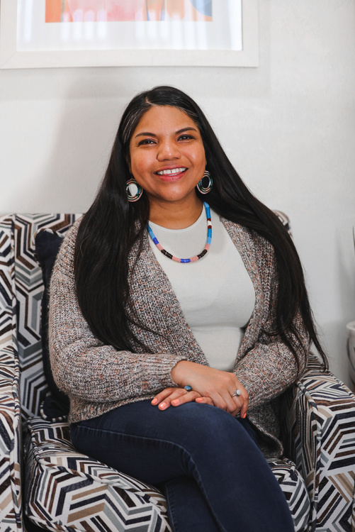 Happy Native American Indian Woman Sitting on the Couch 